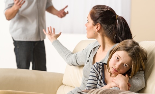 Parents arguing in front of their daughter over a missed visitation