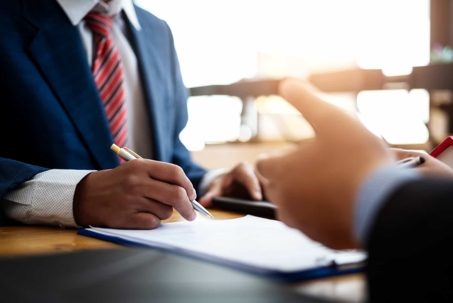 Lawyer meeting with client to discuss business protection during divorce