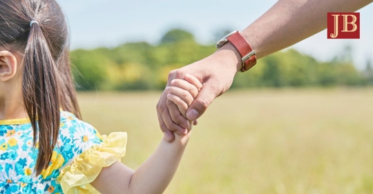 child holding parent's hand